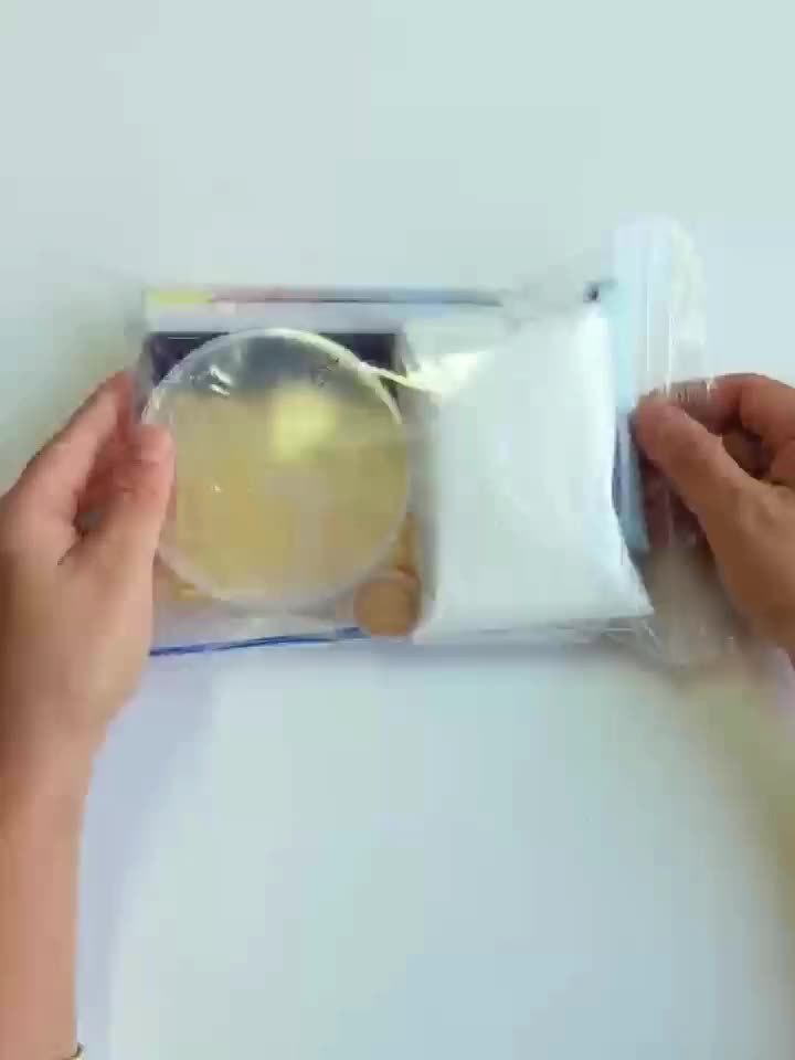 Person holding a clear plastic container with a white background