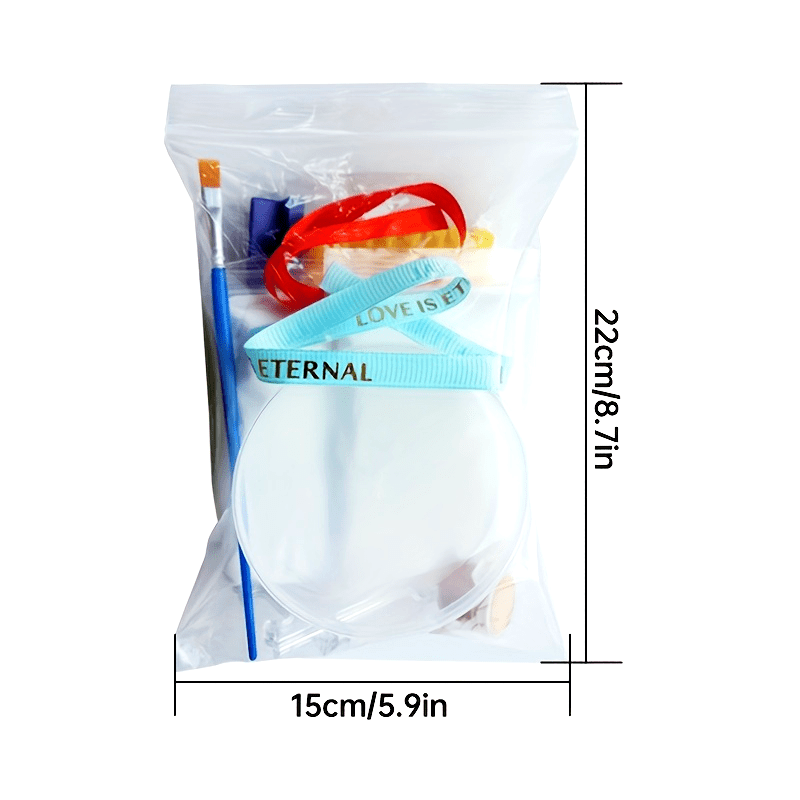 Clear plastic bag with colorful items including a blue brush, red sunglasses, and a white ball labeled 'Eternal'. Dimensions are shown on the sides.