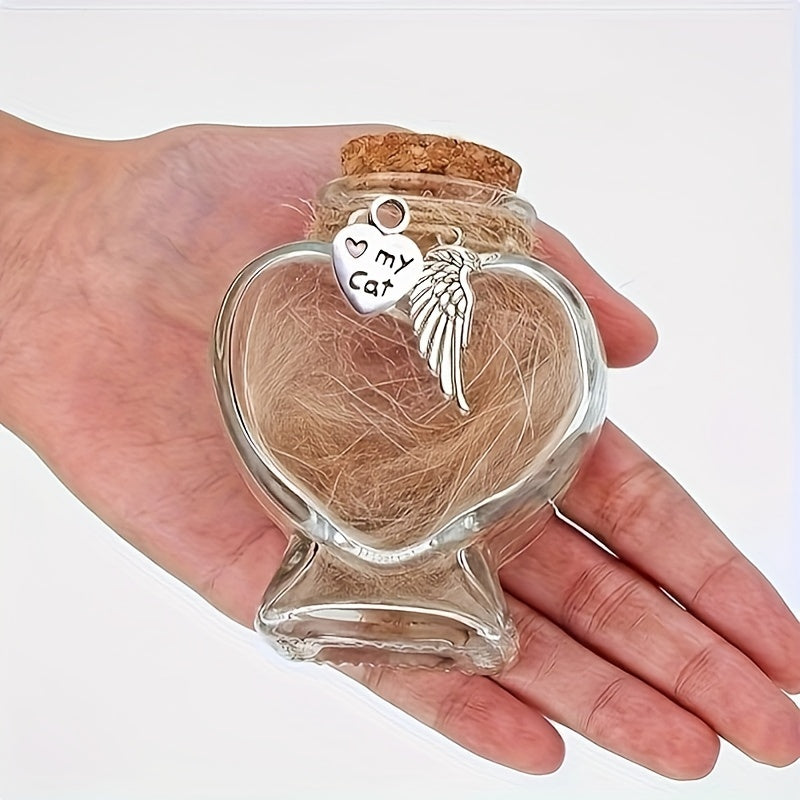 Heart-shaped glass container with cork lid holding pet fur, featuring a silver 'My Cat' charm.