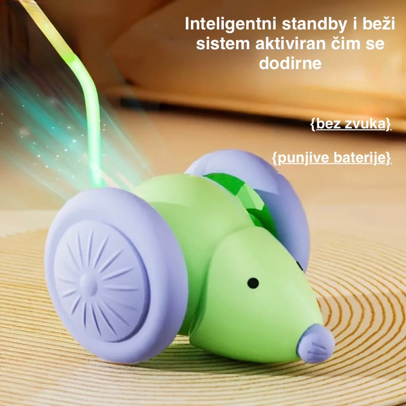 Green and purple toy mouse with glowing tail on a wooden surface